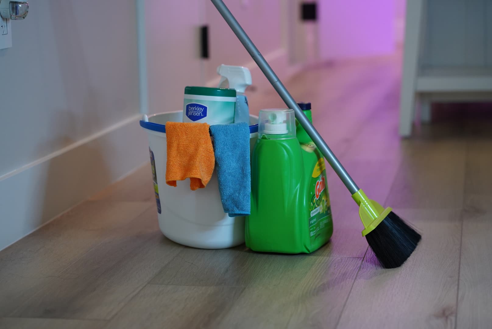 Cleaning supplies including a mop, bucket, cloths, and eco-friendly products, representing professional home cleaning services in New York City