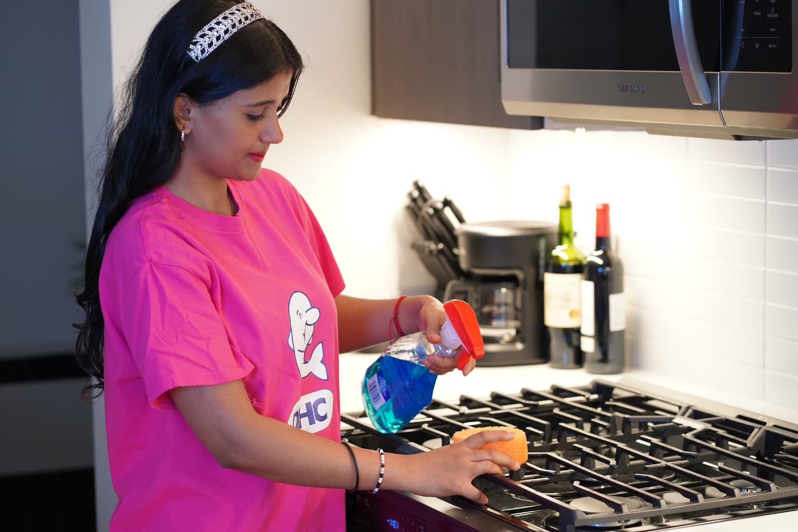 Professional kitchen cleaner sanitizing countertops and maintaining a spotless, organized kitchen in New York City